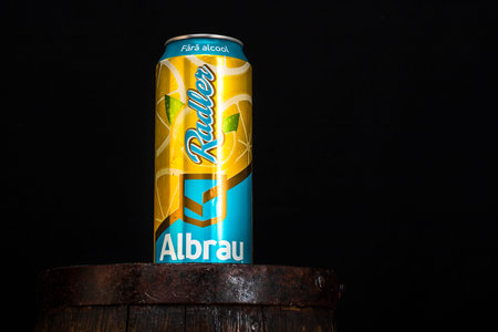 Can of Albrau Radler beer on beer barrel with dark background. Illustrative editorial photo shot in...