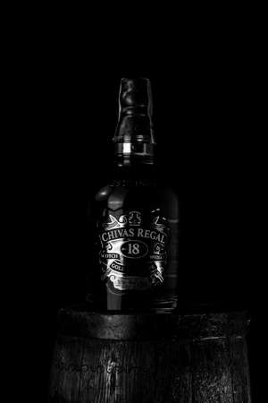Chivas Regal 18 is blended from whiskies matured for at least 18 years. Whisky bottle on barrel. Illustrative editorial photo Bucharest, Romania, 2021のeditorial素材