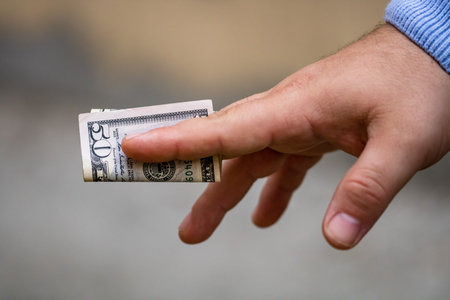 Selective focus on detail of USD banknotes. Counting or giving United States Dollars banknotes....