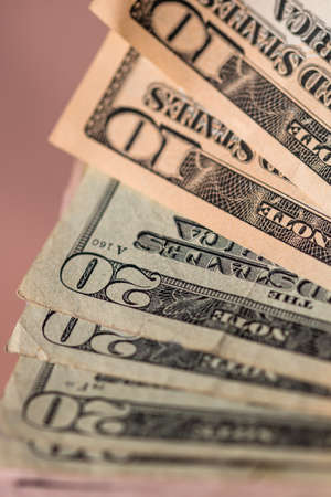 Selective focus on detail of USD banknotes. Counting or giving United States Dollars banknotes. World money concept, inflation and economy conceptの写真素材