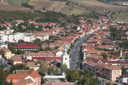 Aerial view of the town center with hills, buildings, streets, vegetation and surroundings in Rupea, Romania, 2021のeditorial素材