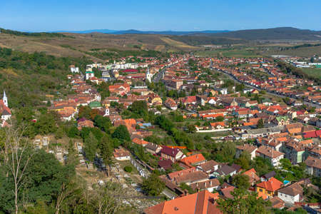 Aerial view of the town center with hills, buildings, streets, vegetation and surroundings in Rupea, Romania, 2021のeditorial素材