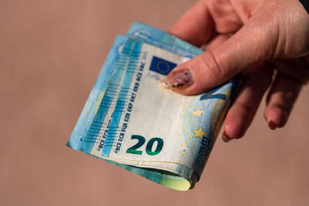 Selective focus on detail of EURO banknotes. Counting or giving EURO banknotes. World money concept, inflation and economy conceptの写真素材