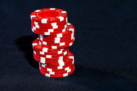 Stack of poker chips on black backgroundの写真素材