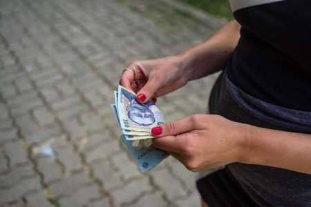 Selective focus on detail of LEI banknotes. Counting or giving Romanian LEI banknotes. World money concept, inflation and economy conceptの写真素材