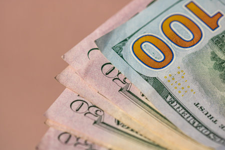 Selective focus on detail of USD banknotes. Counting or giving United States Dollars banknotes....