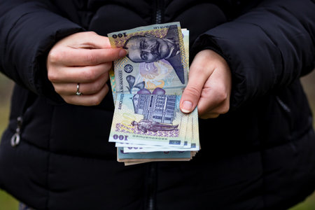 Selective focus on detail of LEI banknotes. Counting or giving Romanian LEI banknotes. World money concept, inflation and economy conceptの写真素材