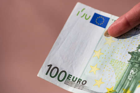 Selective focus on detail of EURO banknotes. Counting or giving EURO banknotes. World money concept, inflation and economy conceptの写真素材