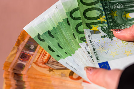 Selective focus on detail of EURO banknotes. Counting or giving EURO banknotes. World money concept,...