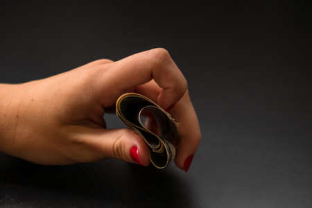 Selective focus on detail of USD banknotes. Counting or giving United States Dollars banknotes. World money concept, inflation and economy conceptの写真素材