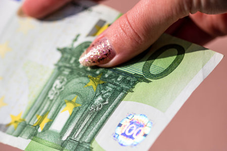 Selective focus on detail of EURO banknotes. Counting or giving EURO banknotes. World money concept,...