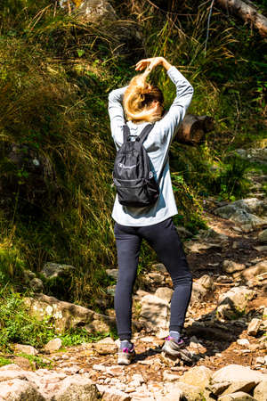 Mountains trip, tourist with backpack hiking through mountain forest in Bihor, Romania, 2021のeditorial素材