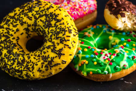 Glazed donuts with sprinkles isolated. Close up of colorful donuts.の写真素材