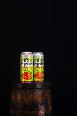 Can of Bergenbier beer on beer barrel with dark background. Illustrative editorial photo Bucharest, Romania, 2021のeditorial素材