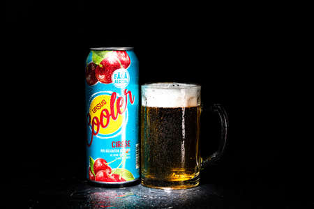 Can of Ursus Cooler beer and beer glass on dark background. Illustrative editorial photo shot in Bucharest, Romania, 2021のeditorial素材