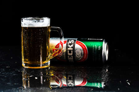 Can of Beck`s or Becks beer and beer glass on dark background. Illustrative editorial photo shot in Bucharest, Romania, 2021のeditorial素材