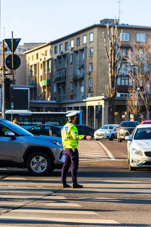 Police agent, Romanian Traffic Police (Politia Rutiera) directing traffic during  rush hour in downtown Bucharest, Romania, 2021のeditorial素材