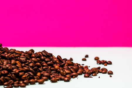 Coffee beans and portafilter with ground coffee in a composition on a pink background.の写真素材