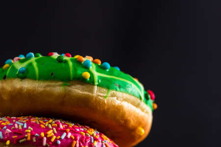 Glazed donuts with sprinkles isolated. Close up of colorful donuts.の写真素材