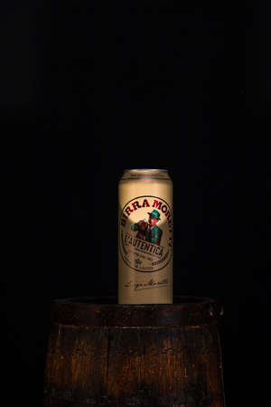 Can of Birra Moretti beer on wooden barrel with dark background. Illustrative editorial photo Bucharest, Romania, 2021のeditorial素材