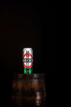 Can of Becks beer on beer barrel with dark background. Illustrative editorial photo Bucharest, Romania, 2021のeditorial素材