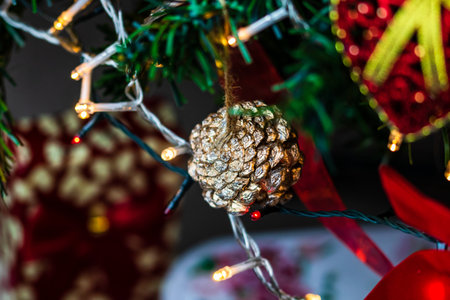 Christmas hanging decorations on fir tree. Decorated Christmas tree. Fir branch with Christmas baubles decorations.の写真素材