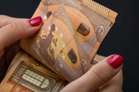 Selective focus on detail of EURO banknotes. Counting or giving EURO banknotes. World money concept,...