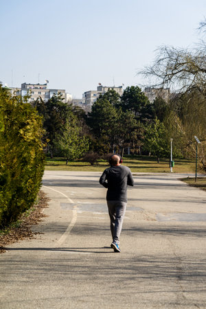 Jogging, running in the city park. Healthy lifestyle, outdoor physical activity and fitness concept in Bucharest, Romania, 2021のeditorial素材