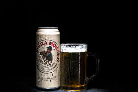 Can of Birra Morreti beer and beer glass on dark background. Illustrative editorial photo shot in Bucharest, Romania, 2021のeditorial素材