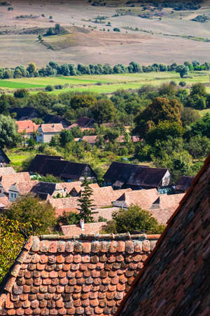 Aerial view of a countryside with vegetation, fields and houses in Romania.の写真素材