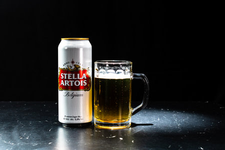 Can of Stella Artois beer and beer glass on dark background. Illustrative editorial photo shot in Bucharest, Romania, 2021のeditorial素材