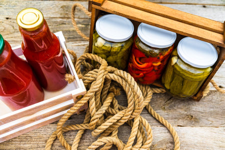 Top view of bottles of tomato sauce, preserved canned pickled food concept isolated in a rustic composition.の写真素材