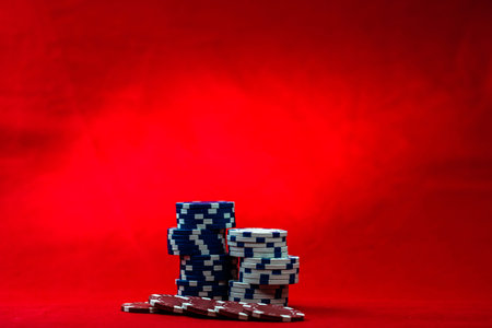 Mix of poker chips on red background
