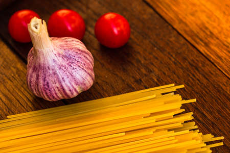 Fresh organic cherry tomatoes with garlic and pastaの写真素材