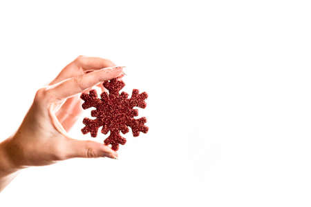 Holding Christmas ornaments against white backgroundの写真素材