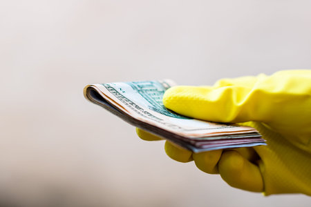 Hand with gloves receiving, giving or holding USD EURO banknote. World money concept