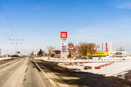 Gas station of the oil company Lukoil, snowy environment in Bucharest, Romania, 2021のeditorial素材