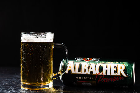 Can of Albacher beer and beer glass on dark background. Illustrative editorial photo shot in Bucharest, Romania, 2021のeditorial素材