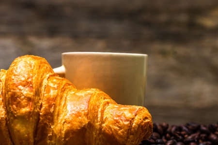 Freshly baked golden brown French croissants. Tasty baked croissants, warm buttery croissants with coffee, breakfast conceptの写真素材