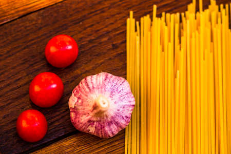 Fresh organic cherry tomatoes with garlic and pastaの写真素材