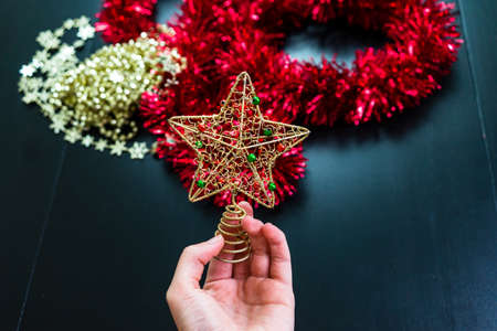 Woman holding in her hands a Christmas decorative ornamentの写真素材