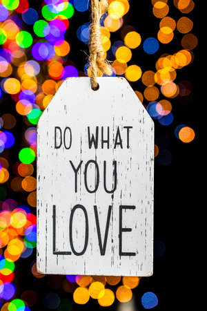 Holding Christmas decoration against bokeh lights backgroundの写真素材