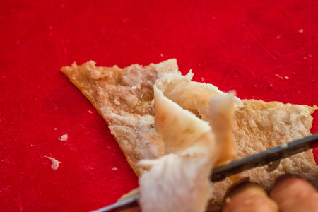 Butcher cutting little pieces of fat pork meat