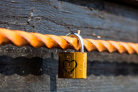 Love symbol, old rusty padlocks hanging on wooden fortress bridge in Alba Iulia, Romania, 2021のeditorial素材