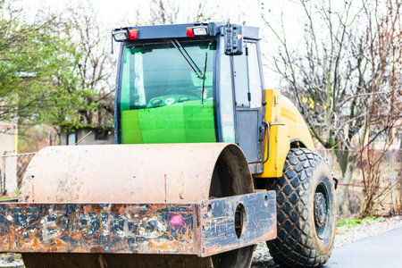 Close up photo of heavy roller machine for asphalt, on the road in traffic. Targoviste, Romania,...