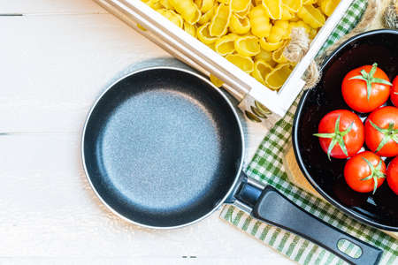 Beautiful tasty Italian pasta, tomatoes, onions and garlic for cooking pastaの写真素材