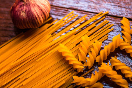 Spaghetti pasta and garlic on wooden tableの写真素材