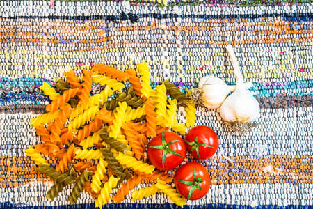 Beautiful tasty Italian pasta, tomatoes, onions and garlic for cooking pastaの写真素材