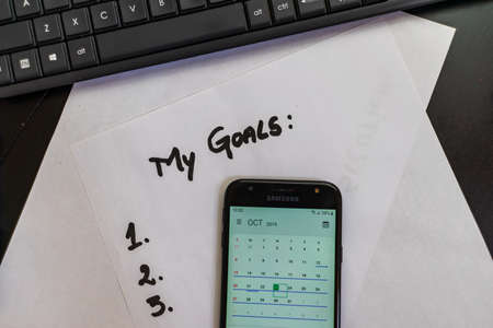 Business concept, laptop and other objects. To do list, goal list, coffee on table in Bucharest, Romania, 2021のeditorial素材