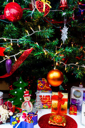 Christmas hanging decorations on fir tree. Decorated Christmas tree. Fir branch with Christmas baubles decorations.のeditorial素材